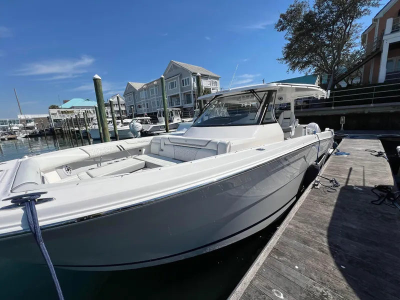 Slide: The Image of 2025 Regal 38 SAV boat on calm water, featuring dual outboard engines. - 3