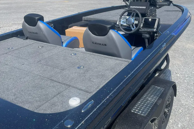 The Image of 2025 Caymas CX 19 PRO boat with dual seats and steering console, parked on a trailer. - 1
