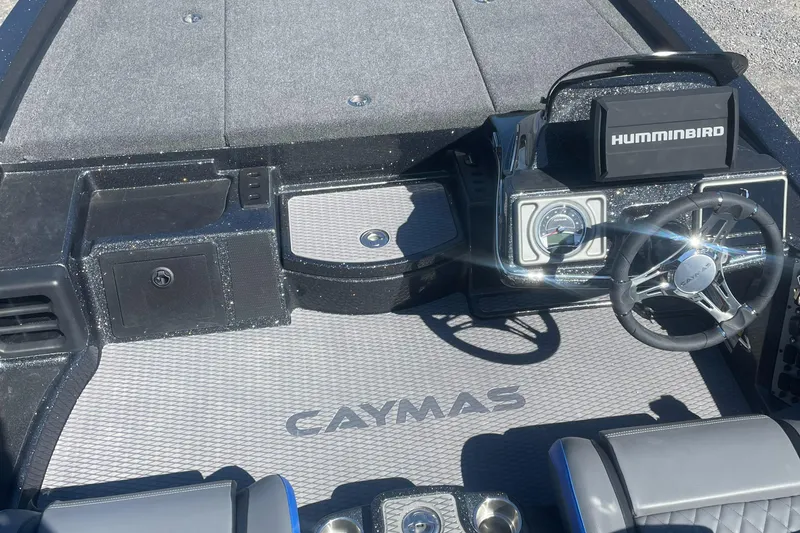 Slide: The Image of 2025 Caymas CX 19 PRO boat interior with steering wheel and Humminbird electronics. - 3