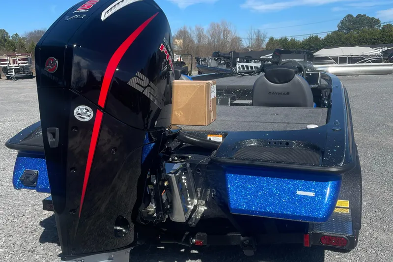 Slide: The Image of 2025 Caymas CX 19 PRO boat with powerful outboard motor in a parking area. - 5