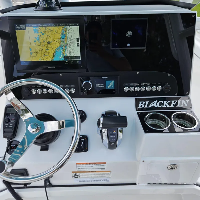 Slide: The Image of 2019 Blackfin 222 CC boat dashboard with navigation system and controls. - 2