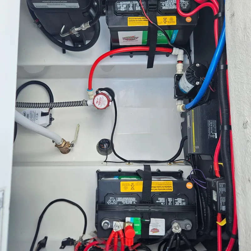Slide: The Image of 2019 Blackfin 222 CC boat battery compartment with wiring and components. - 8