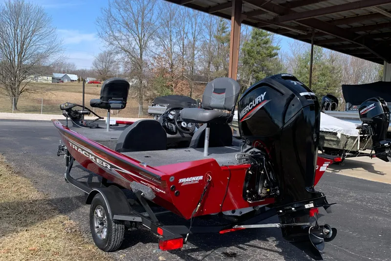 Slide: The Image of 2021 Tracker 175 TXW Tournament Edition boat with Mercury engine, parked outdoors. - 3