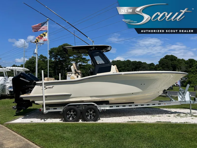 The Image of 2025 Scout 260 LXF boat on trailer at authorized dealer, flags in background. - 0