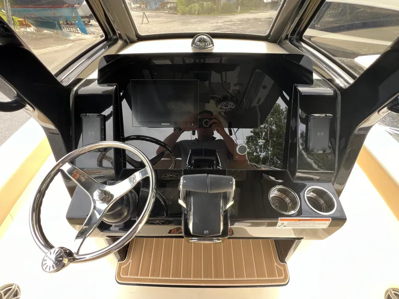Slide: The Image of 2025 Scout 260 LXF boat dashboard with steering wheel and modern controls. - 10
