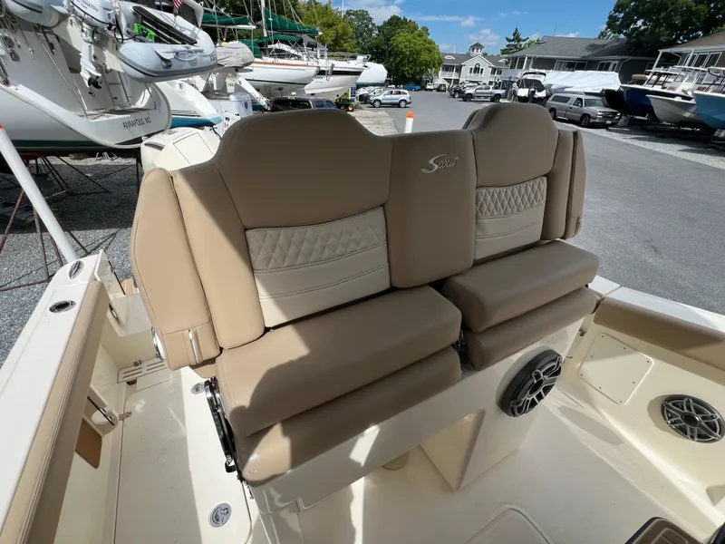 Slide: The Image of 2025 Scout 260 LXF boat seating with beige upholstery and integrated speakers. - 12