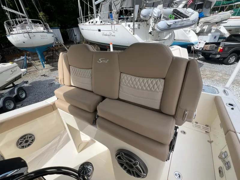Slide: The Image of 2025 Scout 260 LXF boat interior with beige seating and marine speakers. - 13