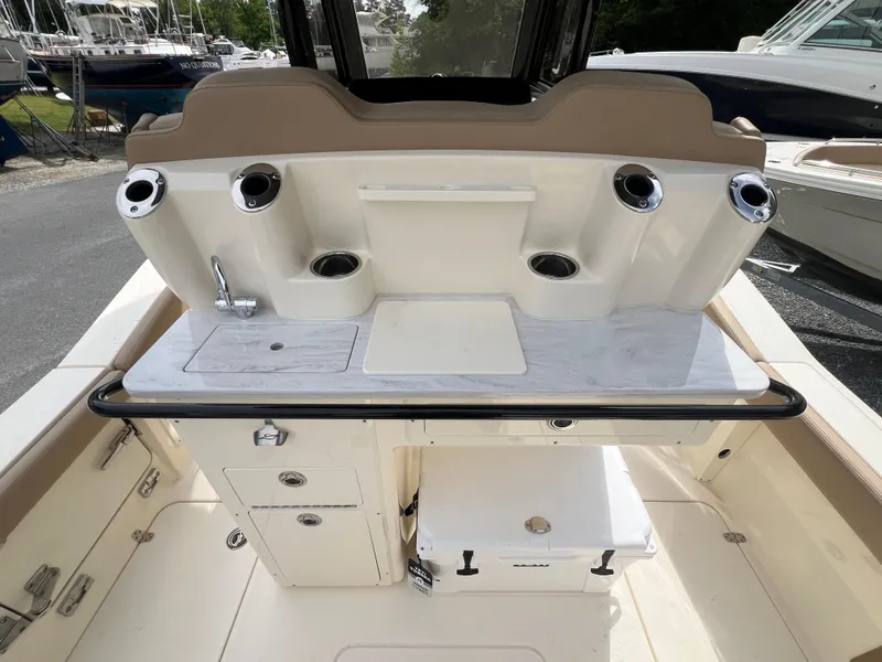 Slide: The Image of 2025 Scout 260 LXF boat interior with fishing rod holders and storage compartments. - 14