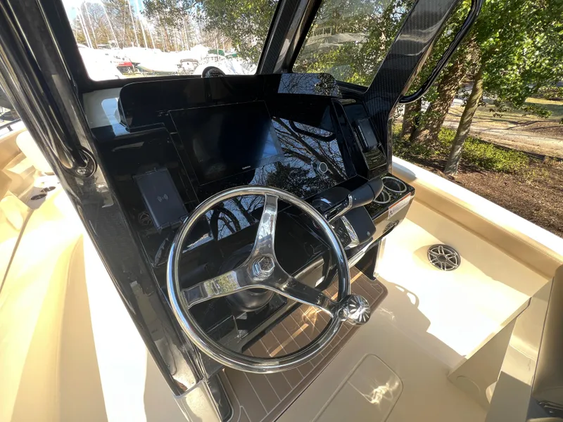 Slide: The Image of 2025 Scout 260 LXF boat dashboard with steering wheel and modern controls. - 15