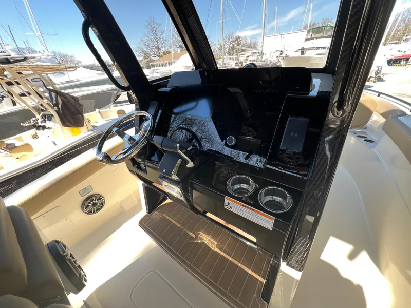 Slide: The Image of 2025 Scout 260 LXF boat cockpit with steering wheel and control panel. - 18