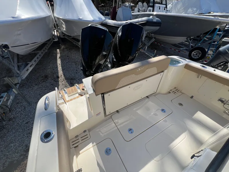 Slide: The Image of 2025 Scout 260 LXF boat with dual engines, beige seating, and spacious deck area. - 20