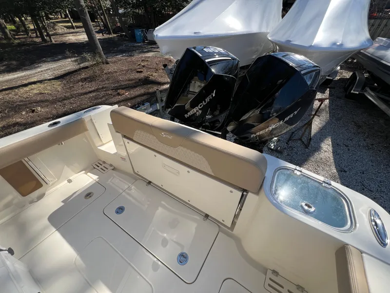 Slide: The Image of 2025 Scout 260 LXF boat with dual Mercury engines, featuring spacious deck and seating. - 21