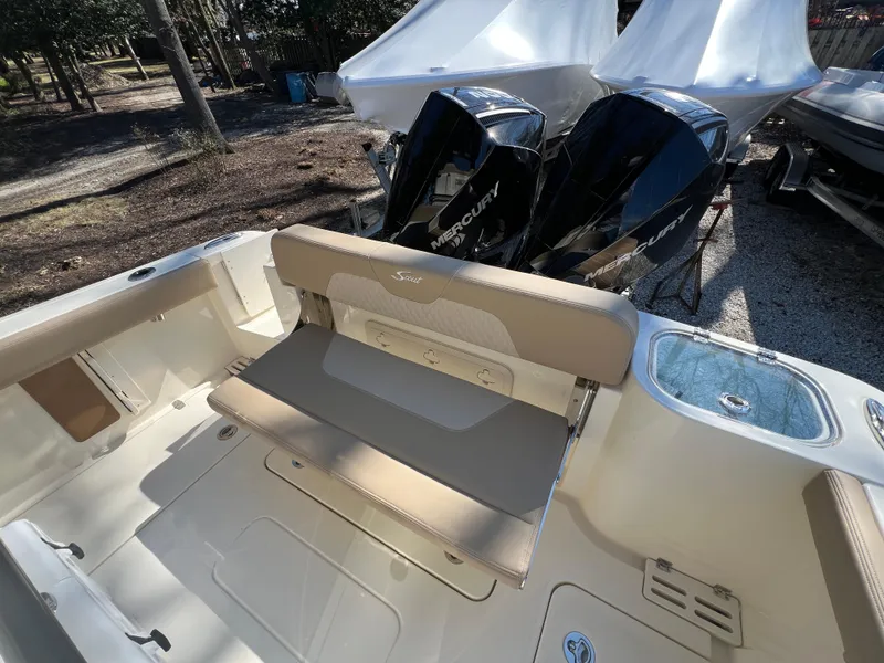 Slide: The Image of 2025 Scout 260 LXF boat with dual Mercury engines and beige seating. - 22