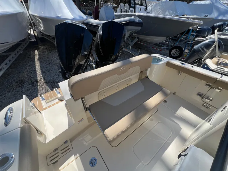 Slide: The Image of 2025 Scout 260 LXF boat interior with seating and dual outboard motors. - 23
