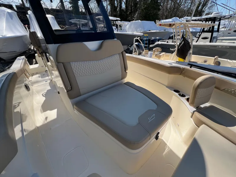 Slide: The Image of 2025 Scout 260 LXF boat interior with beige seating and console. - 24