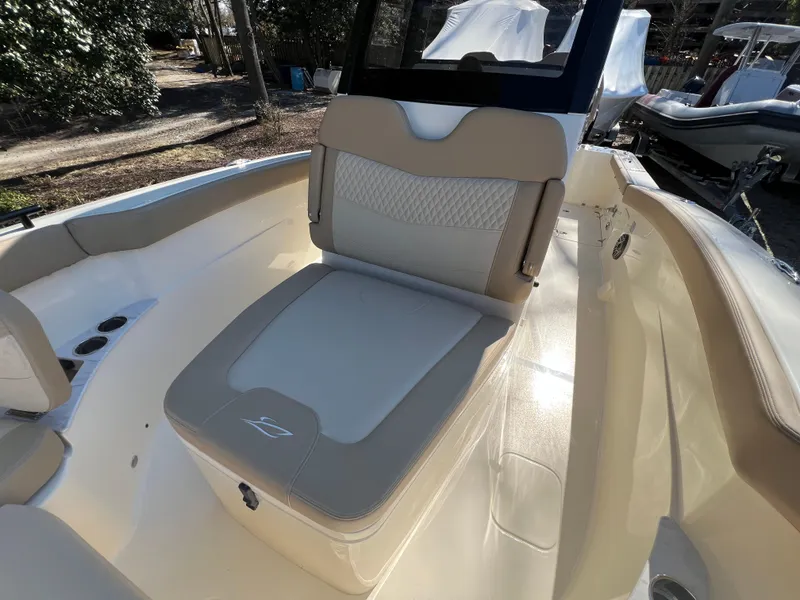 Slide: The Image of 2025 Scout 260 LXF boat interior with beige seating and sleek design. - 25