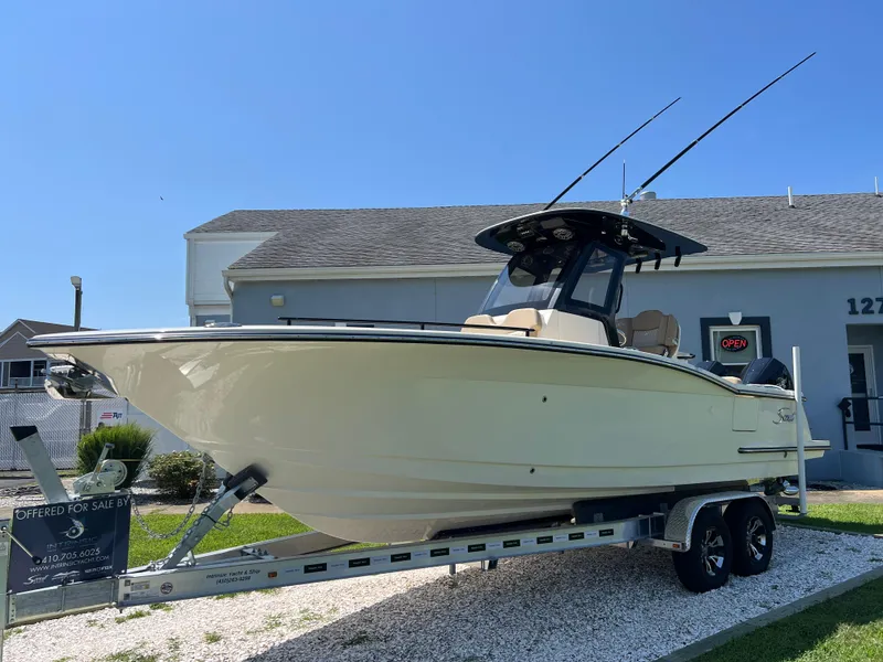 Slide: The Image of 2025 Scout 260 LXF boat on trailer, displayed outdoors, clear sky background. - 4