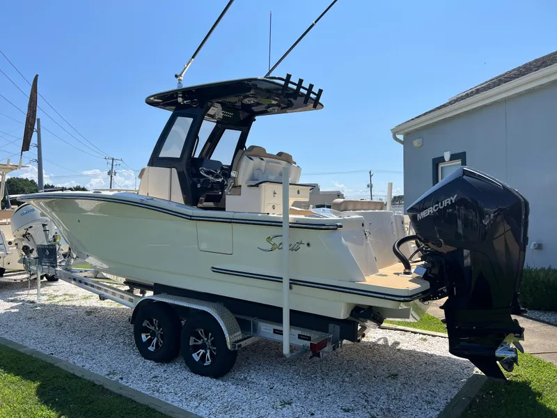 Slide: The Image of 2025 Scout 260 LXF boat on trailer with Mercury engine, parked outdoors. - 5