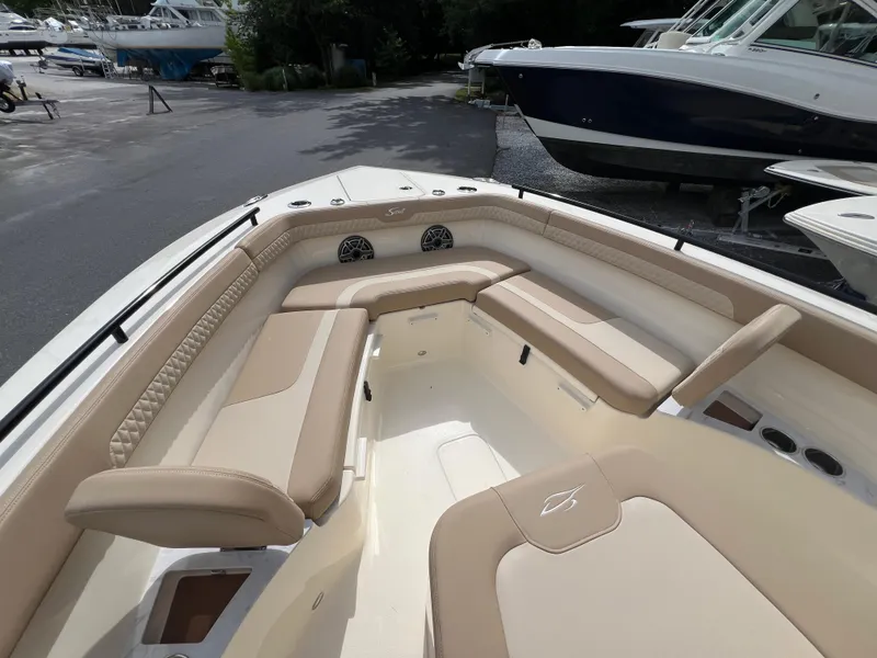 Slide: The Image of 2025 Scout 260 LXF boat interior with beige seating and spacious layout. - 7