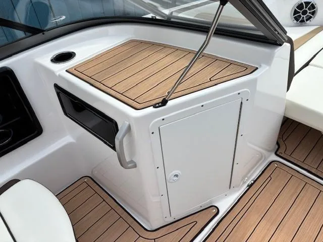 Slide: The Image of 2021 Yamaha Boats 195S interior with sleek wood finish and storage compartment. - 12