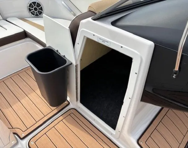 Slide: The Image of 2021 Yamaha Boats 195S interior with storage compartment and trash bin on deck. - 14