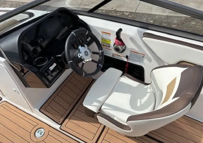 Slide: The Image of 2021 Yamaha Boats 195S cockpit with steering wheel and comfortable seating. - 19