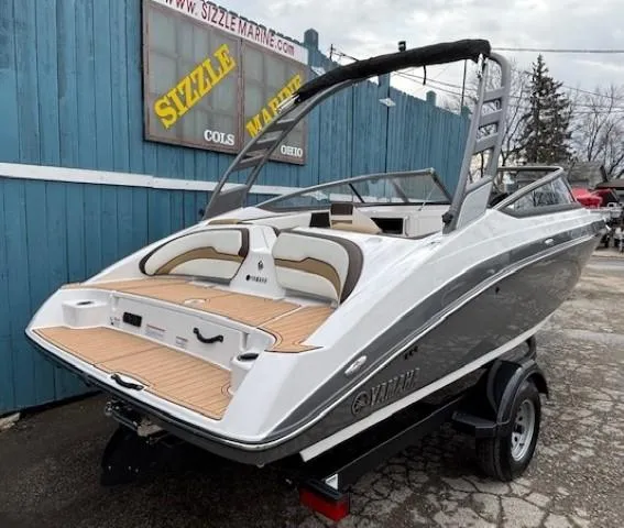 Slide: The Image of 2021 Yamaha Boats 195S, sleek design, parked at Sizzle Marine dealership. - 2