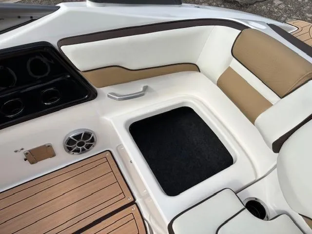Slide: The Image of 2021 Yamaha Boats 195S interior with tan seating and storage compartment. - 26