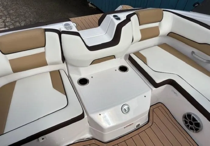 Slide: The Image of 2021 Yamaha Boats 195S interior seating with beige and white upholstery, featuring cup holders. - 28