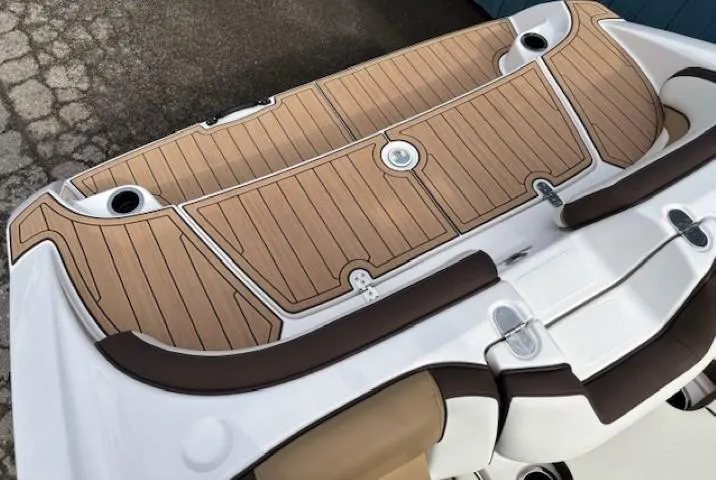 Slide: The Image of 2021 Yamaha Boats 195S swim platform with teak-style decking and cup holders. - 30