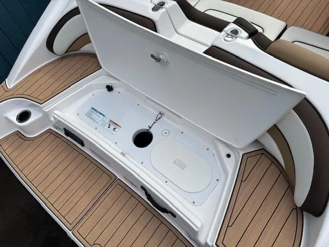 Slide: The Image of 2021 Yamaha Boats 195S storage compartment with open lid, showcasing spacious interior and seating. - 31