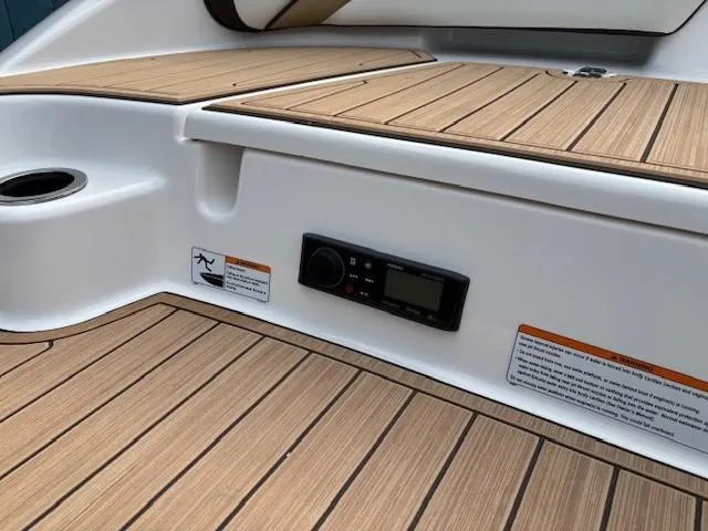 Slide: The Image of 2021 Yamaha Boats 195S interior with teak flooring and control panel. - 32