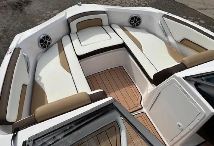 Slide: The Image of 2021 Yamaha Boats 195S interior with cushioned seating and wood flooring. - 7