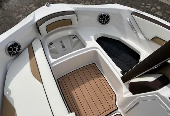 Slide: The Image of 2021 Yamaha Boats 195S interior with seating and speakers, featuring sleek design and wood accents. - 8