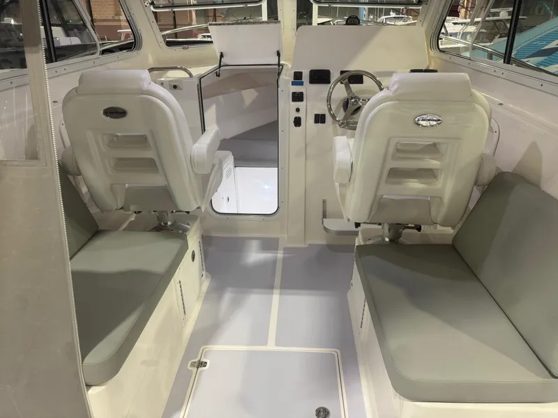 Slide: The Image of 2025 NorthCoast 255 HT interior with white seating and modern helm. - 1