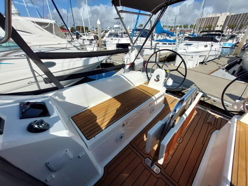 Slide: The Image of Beneteau Oceanis 30.1 yacht cockpit, 2020 model, docked at marina with wooden deck. - 17