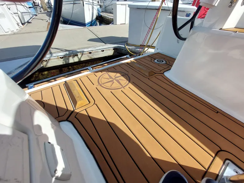 Slide: The Image of Beneteau Oceanis 30.1 yacht deck, 2020 model, featuring teak flooring and steering wheel. - 19