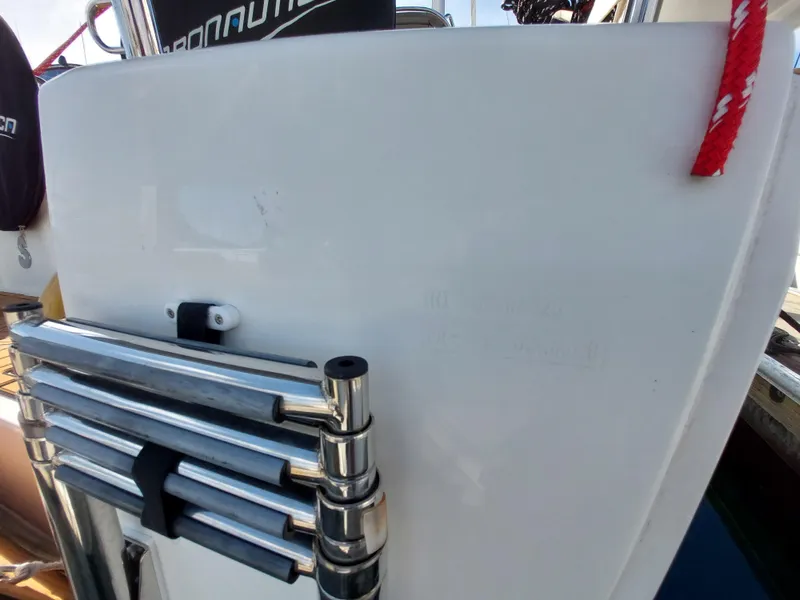 Slide: The Image of Beneteau Oceanis 30.1 (2020) yacht ladder and deck detail with red rope. - 22