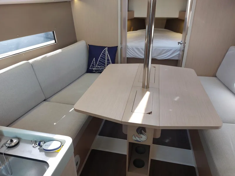 Slide: The Image of Interior of 2020 Beneteau Oceanis 30.1 yacht, featuring cozy seating and dining area. - 33