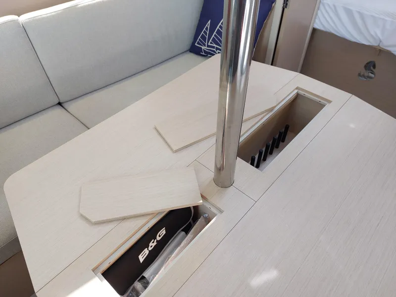 Slide: The Image of Interior of 2020 Beneteau Oceanis 30.1 yacht with table and storage compartments. - 34
