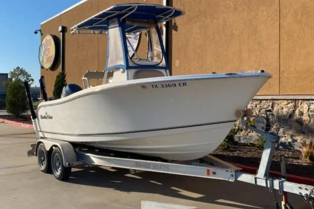 Slide: The Image of 2015 NauticStar 2000XS boat on trailer, parked outdoors. - 2