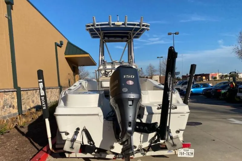 Slide: The Image of 2015 NauticStar 2000XS boat with Yamaha 150 engine, parked outdoors. - 3
