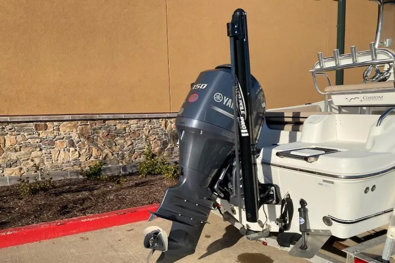 Slide: The Image of 2015 NauticStar 2000XS boat with Yamaha 150 outboard motor, parked outdoors. - 6