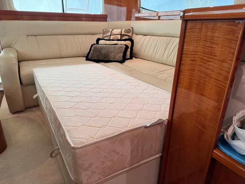 Slide: The Image of Interior of 2005 Riviera 40 Flybridge with beige sofa and pull-out mattress. - 10