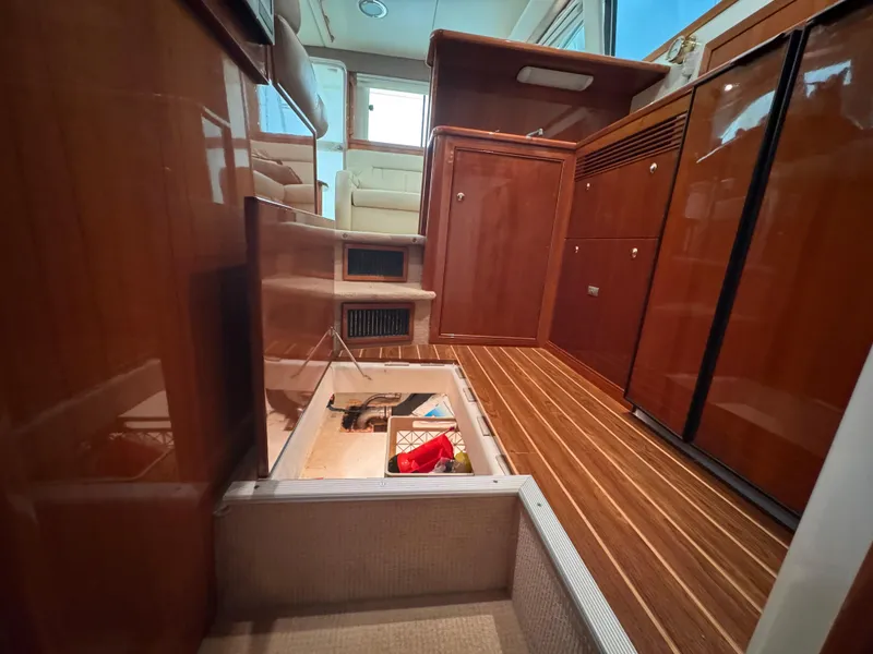 Slide: The Image of Interior of 2005 Riviera 40 Flybridge yacht with wooden cabinetry and flooring. - 16