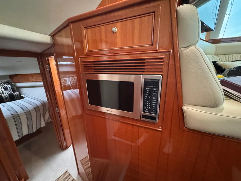Slide: The Image of Interior of 2005 Riviera 40 Flybridge yacht with microwave and cozy cabin. - 17