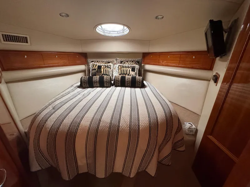 Slide: The Image of Luxurious bedroom interior of 2005 Riviera 40 Flybridge yacht with striped bedding. - 19