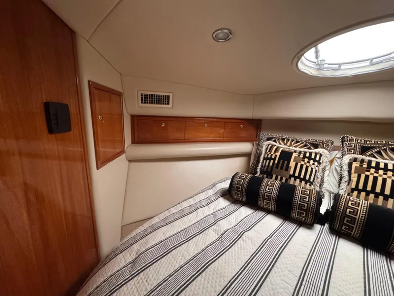 Slide: The Image of Luxurious 2005 Riviera 40 Flybridge cabin with stylish bedding and wood accents. - 20