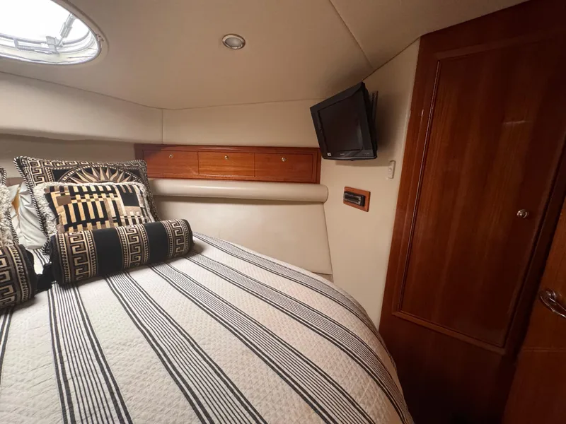 Slide: The Image of Interior of 2005 Riviera 40 Flybridge yacht with cozy bed and TV. - 21