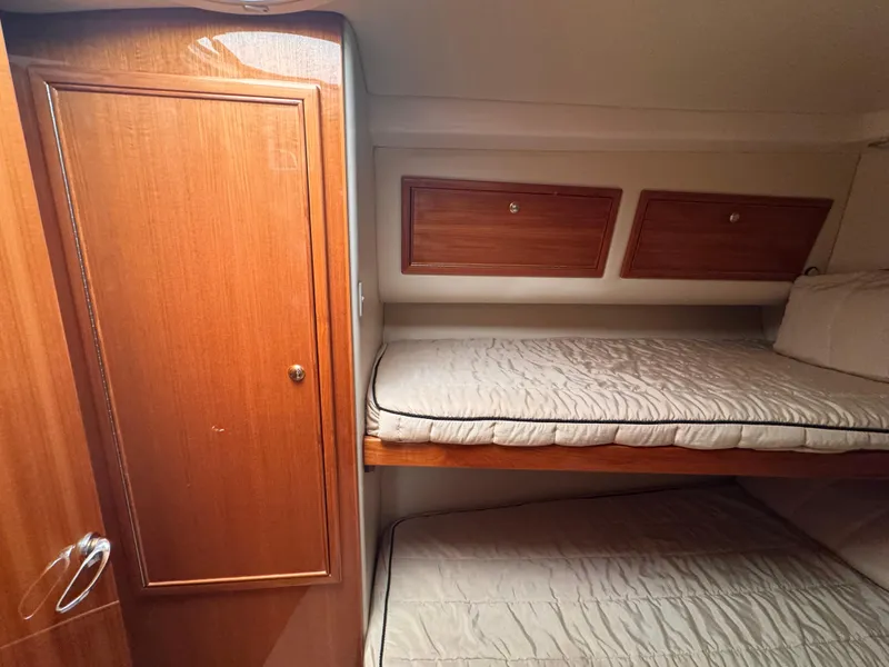 Slide: The Image of Interior of 2005 Riviera 40 Flybridge with wooden cabinets and bunk beds. - 23